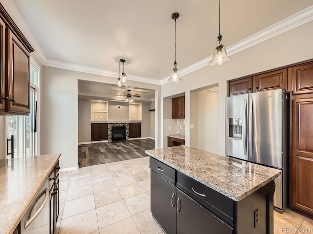 kitchen featuring ceiling fan, hanging light fixtures, appliances with stainless steel finishes, and ornamental molding