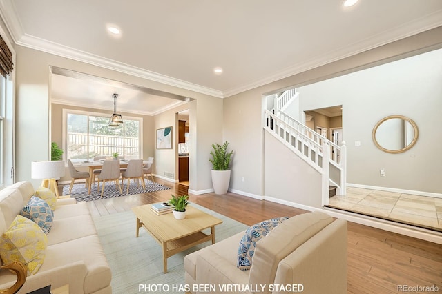 living area with ornamental molding, wood finished floors, recessed lighting, stairway, and baseboards