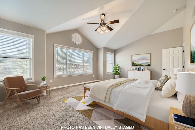 carpeted bedroom featuring baseboards, lofted ceiling, and a ceiling fan