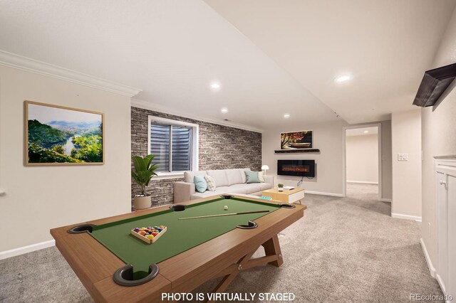 recreation room featuring billiards, a glass covered fireplace, carpet flooring, crown molding, and baseboards