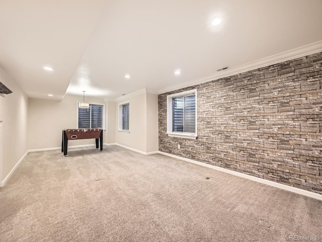 basement featuring visible vents, ornamental molding, recessed lighting, baseboards, and light colored carpet