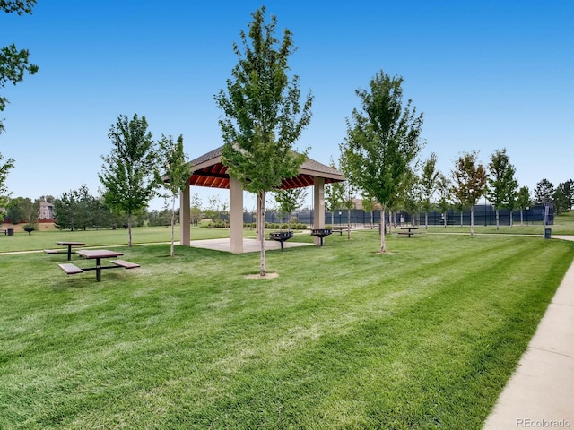 view of home's community featuring a gazebo, a lawn, and fence