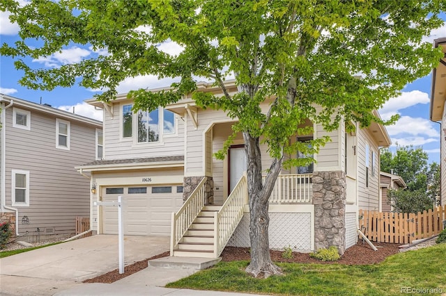 10626 Cherrybrook Cir, Highlands Ranch, CO 80126 - view of front of property featuring stone siding, concrete driveway, and a garage
