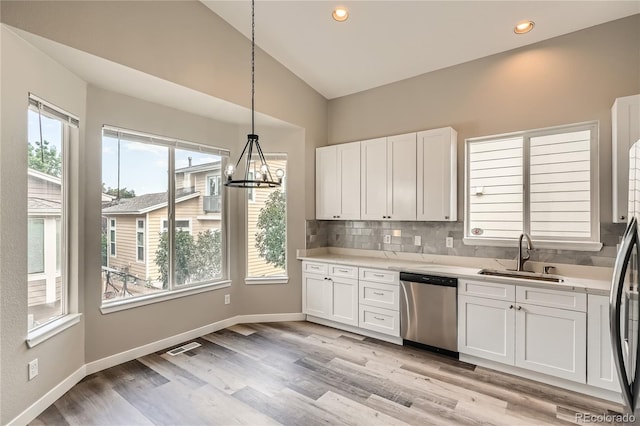 10626 Cherrybrook Cir, Highlands Ranch, CO 80126 - kitchen with dishwasher, light countertops, white cabinets, tasteful backsplash, and recessed lighting