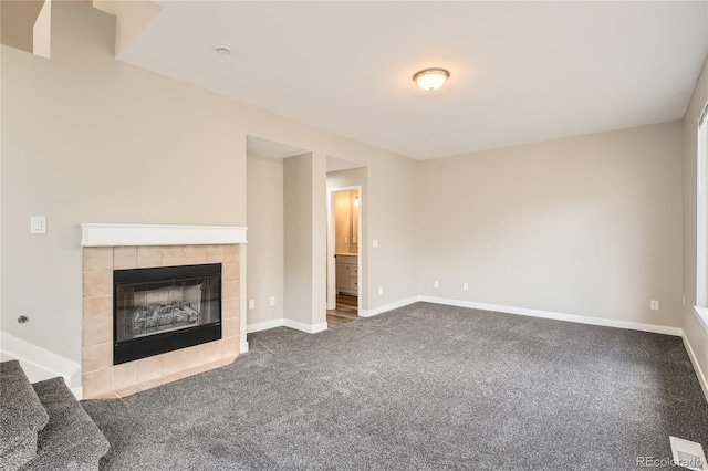 10626 Cherrybrook Cir, Highlands Ranch, CO 80126 - unfurnished living room featuring dark carpet and a tile fireplace