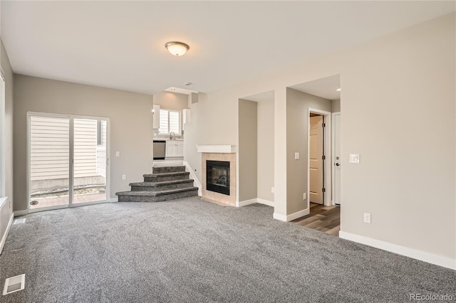 10626 Cherrybrook Cir, Highlands Ranch, CO 80126 - unfurnished living room with carpet and a fireplace