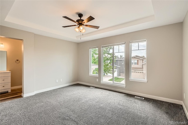 10626 Cherrybrook Cir, Highlands Ranch, CO 80126 - carpeted empty room with a tray ceiling and ceiling fan
