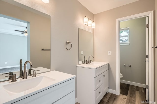 10626 Cherrybrook Cir, Highlands Ranch, CO 80126 - bathroom with wood finished floors, two vanities, and a ceiling fan