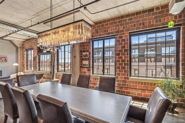 1863 Wazee St Unit 6B, Denver, CO 80202 - dining room featuring a chandelier and brick wall