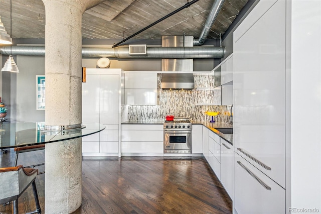 1863 Wazee St Unit 6B, Denver, CO 80202 - kitchen featuring high end stove, white cabinets, dark wood-type flooring, decorative columns, and tasteful backsplash