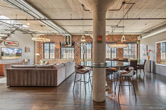 1863 Wazee St Unit 6B, Denver, CO 80202 - dining area with brick wall, dark wood finished floors, and a chandelier