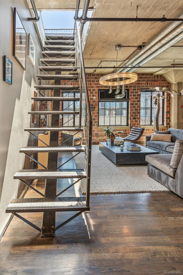 1863 Wazee St Unit 6B, Denver, CO 80202 - staircase with wood finished floors, brick wall, and a chandelier