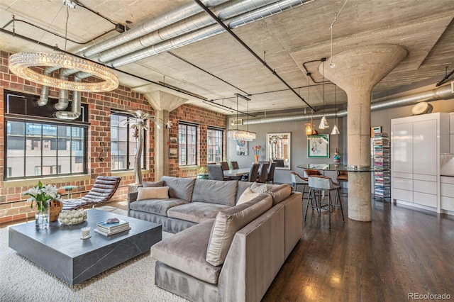 1863 Wazee St Unit 6B, Denver, CO 80202 - living room with wood finished floors, brick wall, a chandelier, and plenty of natural light
