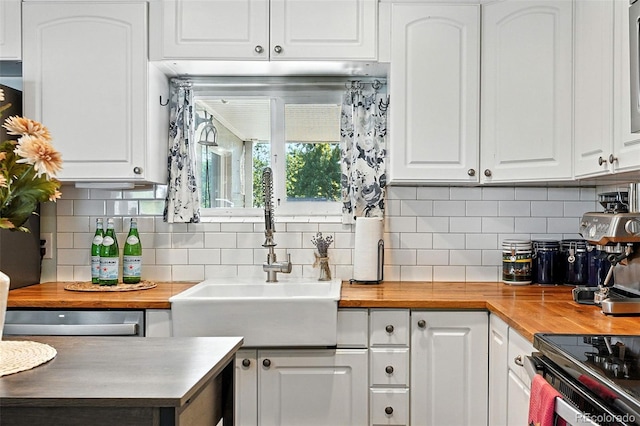 4315 S Elati St, Englewood, CO 80110 - kitchen featuring wood counters, white cabinets, and tasteful backsplash