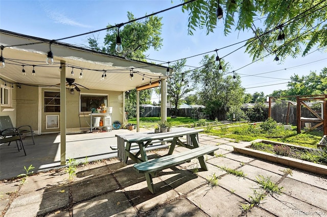 4315 S Elati St, Englewood, CO 80110 - fenced backyard featuring outdoor dining space, a vegetable garden, a patio area, and a ceiling fan