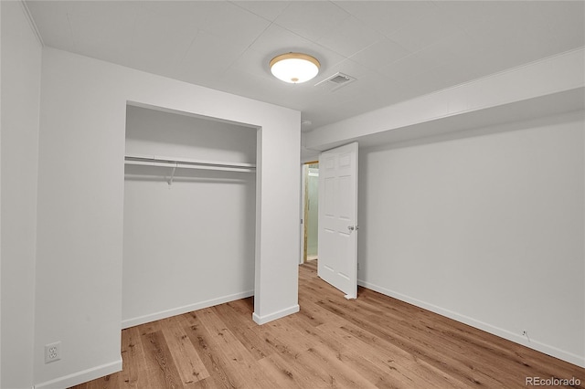 641 E 104th Pl, Northglenn, CO 80233 - unfurnished bedroom featuring wood finished floors, a closet, and baseboards