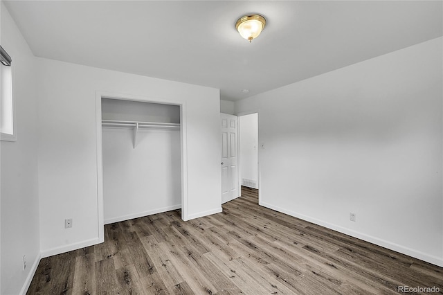 641 E 104th Pl, Northglenn, CO 80233 - unfurnished bedroom with wood finished floors, baseboards, and a closet