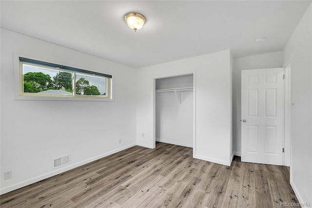 641 E 104th Pl, Northglenn, CO 80233 - unfurnished bedroom with wood finished floors, a closet, and baseboards