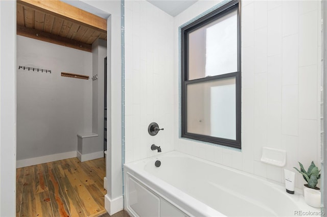 bathroom featuring wood ceiling, hardwood / wood-style flooring, and bathtub / shower combination