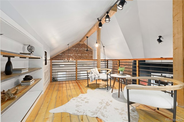 living area with hardwood / wood-style floors and vaulted ceiling with beams