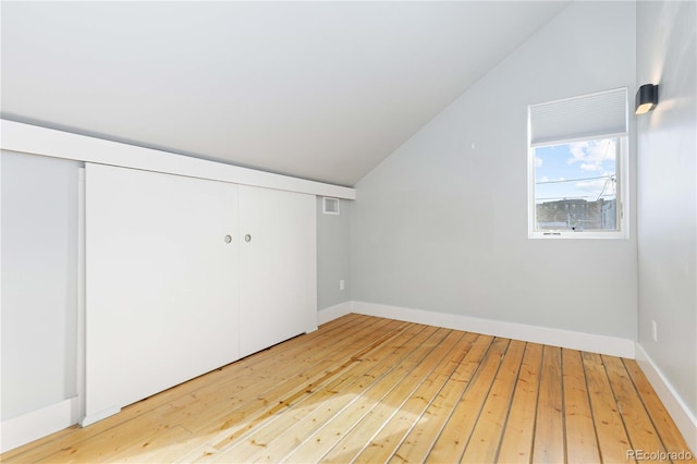 bonus room featuring wood-type flooring and vaulted ceiling