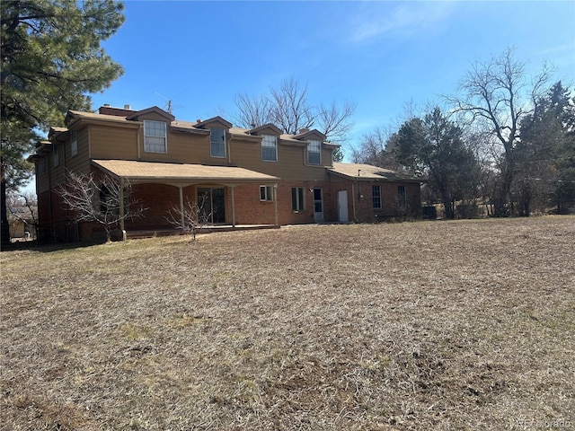 rear view of property featuring brick siding