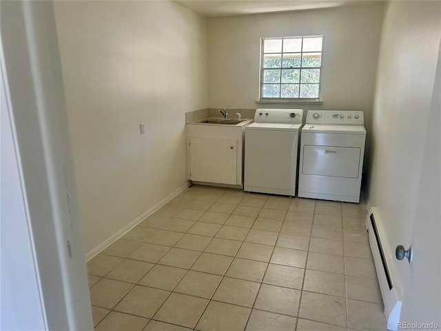 laundry room featuring baseboards, a baseboard radiator, light tile patterned flooring, a sink, and washer and clothes dryer