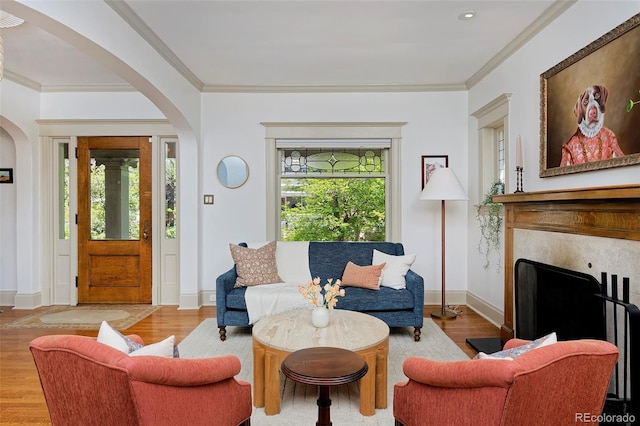 747 N Downing St, Denver, CO 80218 - living room featuring arched walkways, wood finished floors, crown molding, and baseboards