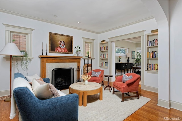 747 N Downing St, Denver, CO 80218 - sitting room with built in features, a fireplace, wood finished floors, ornamental molding, and healthy amount of natural light