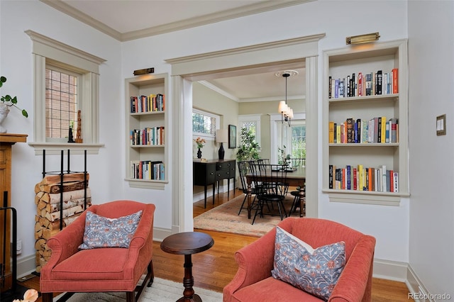 747 N Downing St, Denver, CO 80218 - sitting room with wood finished floors, ornamental molding, a chandelier, and built in shelves