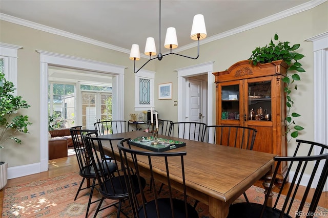 747 N Downing St, Denver, CO 80218 - dining space with ornamental molding, light wood-style floors, baseboards, and a chandelier