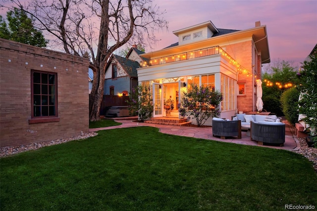747 N Downing St, Denver, CO 80218 - back of property at dusk featuring an outdoor living space, a yard, a chimney, a patio area, and central air condition unit