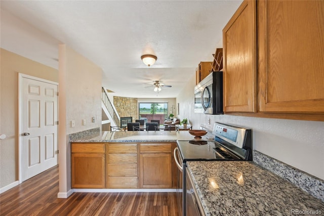 7474 E Arkansas Ave Unit 13-02, Denver, CO 80231 - kitchen featuring stainless steel appliances, a ceiling fan, dark wood-type flooring, and brown cabinetry