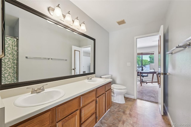 7474 E Arkansas Ave Unit 13-02, Denver, CO 80231 - bathroom with toilet, double vanity, and baseboards