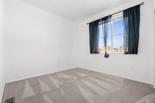 unfurnished room with visible vents, carpet flooring, and baseboards