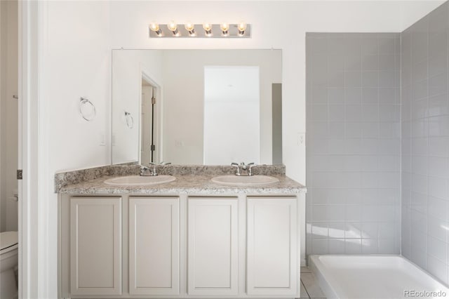 full bath featuring a sink, toilet, and double vanity