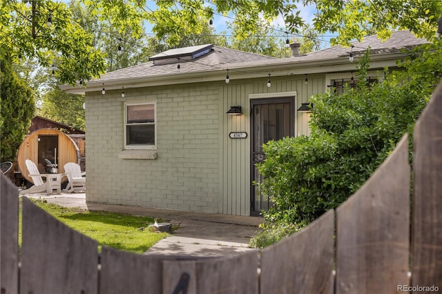 4567 Grove St, Denver, CO 80211 - doorway to property with a shingled roof and brick siding