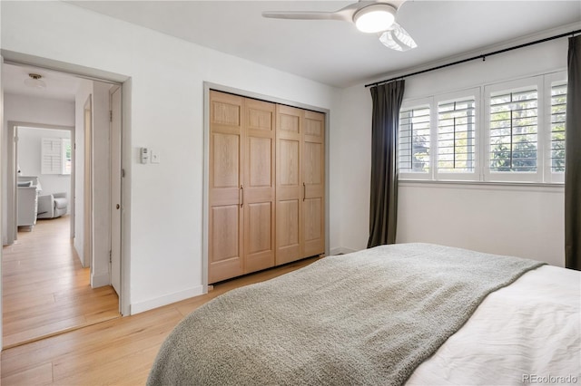 4567 Grove St, Denver, CO 80211 - bedroom with light wood finished floors, a closet, baseboards, and ceiling fan