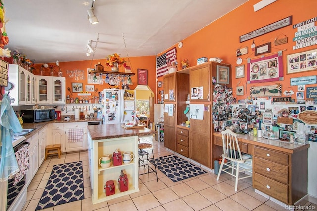 222 S Logan St, Grover, CO 80729 - kitchen featuring black microwave, freestanding refrigerator, open shelves, and light tile patterned floors