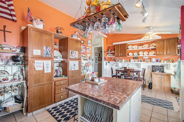 222 S Logan St, Grover, CO 80729 - kitchen with open shelves, light tile patterned floors, ceiling fan, and track lighting