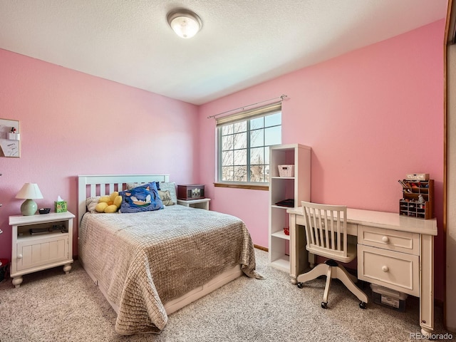 bedroom featuring light carpet and a textured ceiling