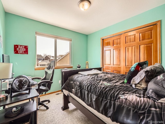 bedroom with visible vents, a closet, baseboards, and carpet flooring