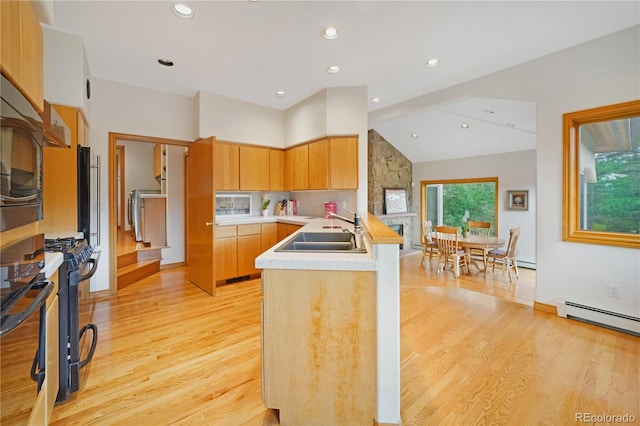 2398 Bitterroot Ln, Golden, CO 80401 - kitchen featuring light wood-style flooring, light countertops, a peninsula, a baseboard heating unit, and recessed lighting