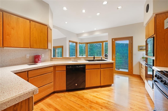 2398 Bitterroot Ln, Golden, CO 80401 - kitchen featuring black appliances, light wood finished floors, recessed lighting, tasteful backsplash, and brown cabinets