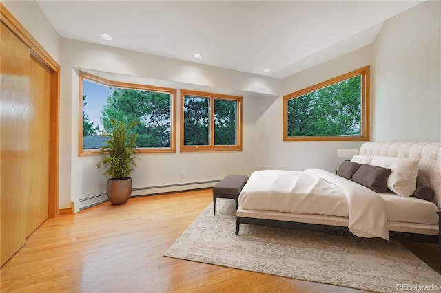 2398 Bitterroot Ln, Golden, CO 80401 - bedroom featuring light wood-style flooring, recessed lighting, and a baseboard heating unit