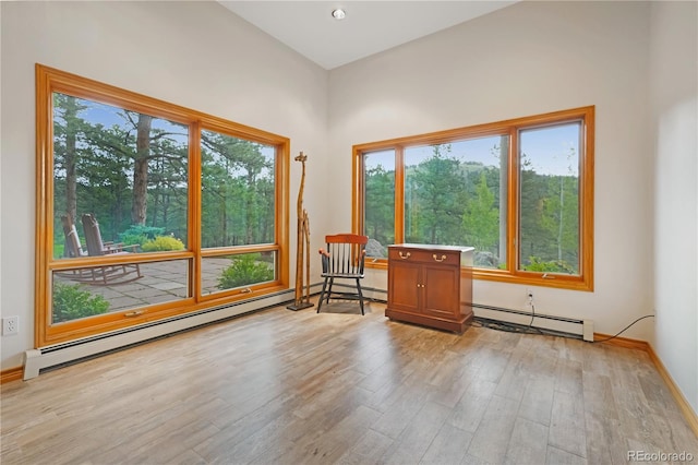 2398 Bitterroot Ln, Golden, CO 80401 - unfurnished room featuring a baseboard heating unit, wood finished floors, and healthy amount of natural light