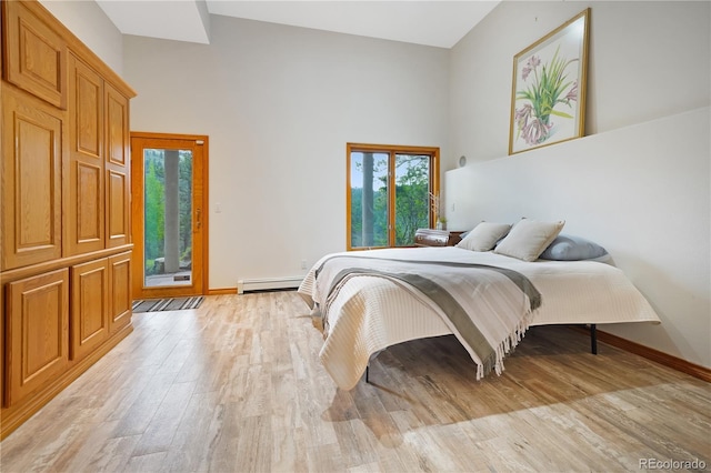 2398 Bitterroot Ln, Golden, CO 80401 - bedroom with baseboard heating, a high ceiling, light wood-type flooring, and access to exterior