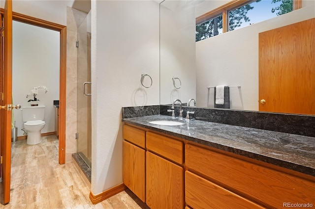 2398 Bitterroot Ln, Golden, CO 80401 - bathroom featuring wood finished floors, a shower stall, and vanity