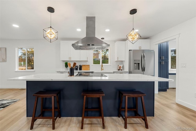 kitchen with white cabinets, stainless steel fridge with ice dispenser, island range hood, and a large island