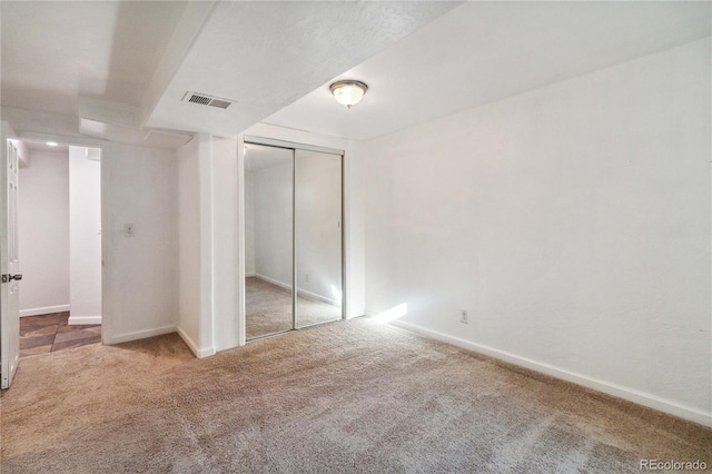 unfurnished bedroom featuring carpet floors and a closet